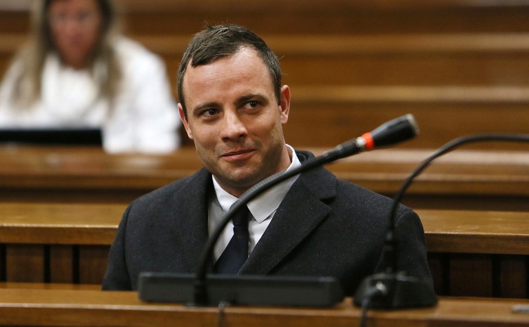 FILE - In this Tuesday, July 8, 2014 file photo Oscar Pistorius sits in the dock in Pretoria, South Africa, at his murder trial for the shooting death of his girlfriend Reeva Steenkamp on St. Valentine's Day, 2013. In newspaper reports Pistorius has been accused of an aggressive altercation at a Johannesburg nightclub he visited at the weekend.  A spokeswoman for the Pistorius family said an argument ensued and the athlete, who is free on bail, soon left the club. He had been seated in a quiet booth in the VIP section, she said in a statement. (AP Photo/Alon Skuy, Pool, File)