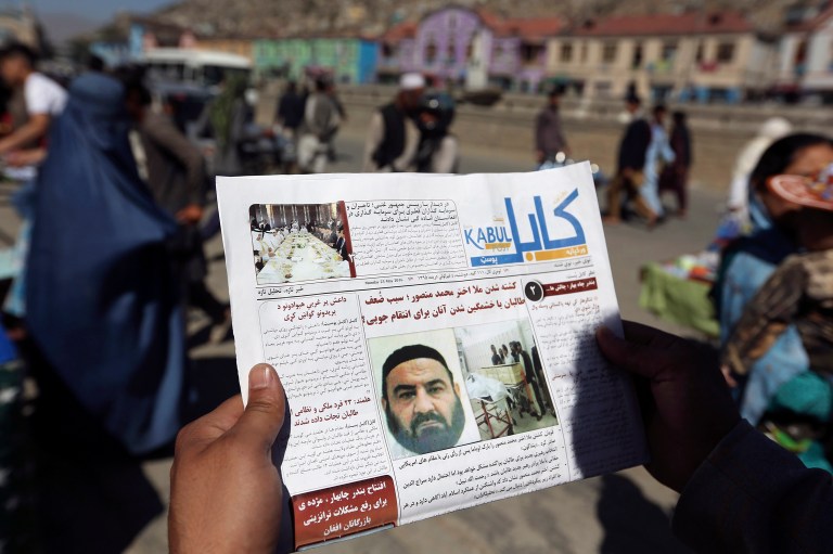 In this May 25, 2016, file photo, an Afghan man reads a local newspaper with photos the former leader of the Afghan Taliban, Mullah Akhtar Mansoor, who was killed in a U.S. drone strike in Kabul, Afghanistan. (AP Photo/Rahmat Gul, File)