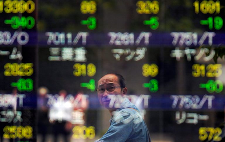   A man looks at the electronic stock board of a securities firm in Tokyo Friday, June 8, 2012. Asian stock markets fell Friday, deflated after U.S. Federal Reserve Chairman Ben Bernanke gave no hint of immediate action to jump-start growth in the world's No. 1 economy. Japan's Nikkei 225 index fell 2 percent to 8,471.04. (AP Photo/Itsuo Inouye)  