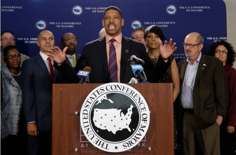 In this Sept. 29, 2014, Sacramento Mayor Kevin Johnson, president of the United States Conference of Mayors, holds a news conference accompanied by the mayors of other cities, in Sacramento, Calif.  Johnson is backing a local proposition on the November ballot to increase the powers of the mayor's  office in Sacramento.(AP Photo/Rich Pedroncelli)