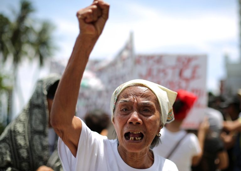 Filipino Narcisa Claveria, 84, who claims to have been a sex slave during World War II, shouts slogans during a rally in front of the Japanese Embassy in Manila, Philippines Wednesday, June 25, 2014. A group of alleged Filipino 