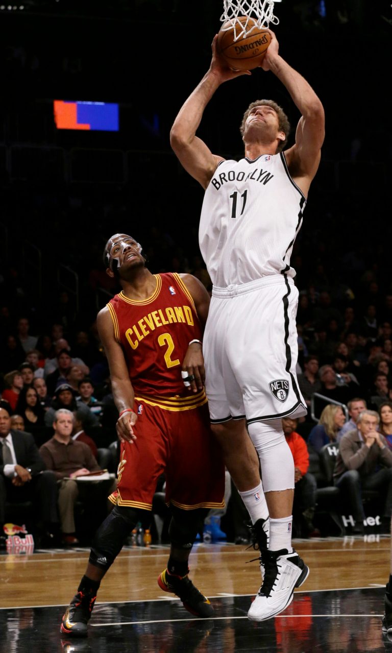   Brooklyn Nets' Brook Lopez (11) shoots next to Cleveland Cavaliers' Kyrie Irving (2) during the first half of an NBA basketball game Saturday, Dec. 29, 2012, in New York. (AP Photo/Frank Franklin II)  