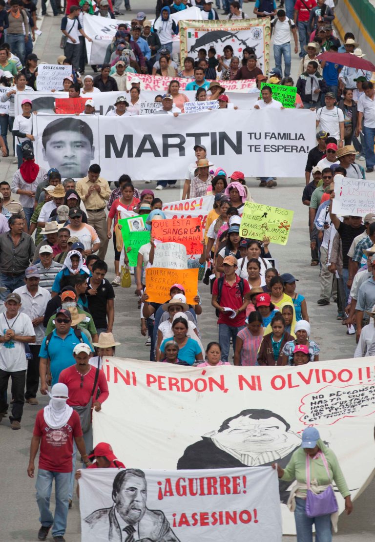 People protest the disappearance of 43 students from the Isidro Burgos rural teachers college and demand authorities find them in Chilpancingo, Mexico, Wednesday, Oct. 8, 2014. Federal officials say they still have no explanation for violence Sept. 26 that killed six, wounded at least 25 and left so many missing. Also, investigators still had no word on whether the 28 bodies found in a mass grave last weekend included some of the missing students. (AP Photo/Eduardo Verdugo)
