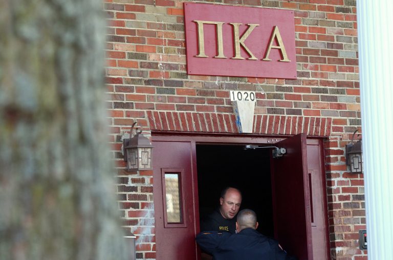   In this Nov. 2, 2012 photo, DeKalb police Sgt. Jason Leverton speaks with an Northern Illinois University police officer in the doorway of the Pi Kappa Alpha house in DeKalb, Ill. where police were investigating the death of NIU freshman David Bogenberger. Nearly two dozen Pi Kappa Alpha members at Northern Illinois University have been charged with hazing-related counts after Bogenberger was found dead at their fraternity house following a night of drinking. (AP Photo/Daily Chronicle, Kyle Bursaw) CHICAGO LOCALS OUT; ROCKFORD REGISTER STAR OUT; MANDATORY CREDIT  