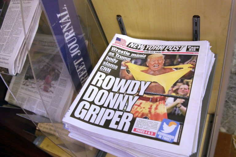Copies of the New York Post with an illustration of President Donald Trump as a professional wrestler on the front page are displayed at a newsstand in New York City, Monday, July 3, 2017. (AP Photo/Richard Drew)
