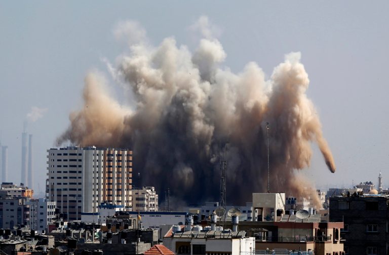 FILE - In this Friday, Aug. 8, 2014 file photo, smoke, dust and debris rise over Gaza City after an Israeli strike. The Palestinian economy is expected to contract for the first time in seven years in 2014, shrinking by 4 percent, the result of the recent Gaza war, continued Israeli and Egyptian restrictions on Palestinian trade and a drop in foreign aid, the World Bank said Tuesday. The downturn is expected to be sharpest in war-battered Gaza, with a projected drop of 15 percent, the bank said. (AP Photo/Hatem Moussa, File)