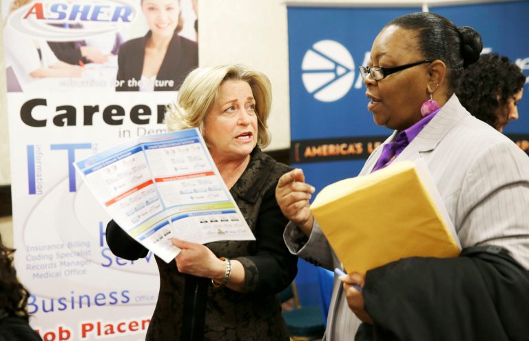 FILE - In this Wednesday, Jan. 22, 2014, file photo, recruiter Valera Kulow, left, speaks with job seeker Monic Spencer during a career fair in Dallas. Payroll processor ADP reports on job growth at U.S. companies in April on Wednesday, April 30, 2014. (AP Photo/LM Otero, File)