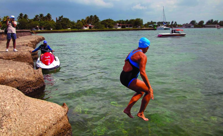 U.S. swimmer Diana Nyad jumps into the water to start her swim to Florida from Havana, Cuba, Saturday, Aug. 18, 2012. Endurance athlete Nyad launched another bid Saturday to set an open-water record by swimming from Havana to the Florida Keys without a protective shark cage. (AP Photo/Ramon Espinosa)