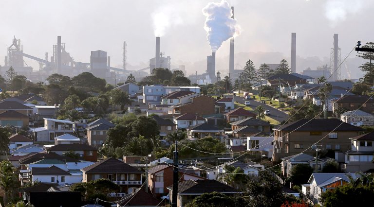 In this Wednesday, July 2, 2014 photo, smoke billows out of a chiming chimney stack of a steel works factories in Port Kembla 86 kilometers (53 miles) south of Sydney. The Senate is expected to vote as early as Monday, July 7, 2014, to repeal an unpopular, two-year-old tax charged to around 300 of the country's biggest carbon polluters. (AP Photo/Rob Griffith)