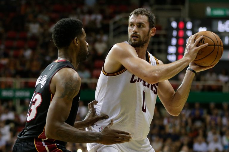 Cleveland Cavaliers' Kevin Love, right, moves the ball under pressure from Miami Heat's Shawne Williams during a NBA preseason basketball game that's part of the NBA Global Games in Rio de Janeiro, Brazil, Saturday, Oct. 11, 2014. (AP Photo/Felipe Dana)