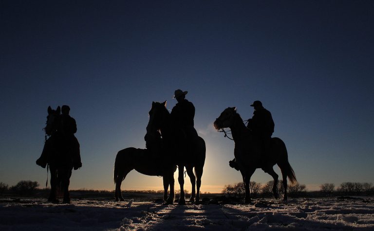   In this Dec. 12, 2012, photo, riders participate in the Dakota 38 Plus 2 memorial ride near Woonsocket, South Dakota. The riders left from Crow Creek and are expected to arrive Tuesday in Mankato, Minn. (AP Photo/Daily Republic, Chris Huber)  
