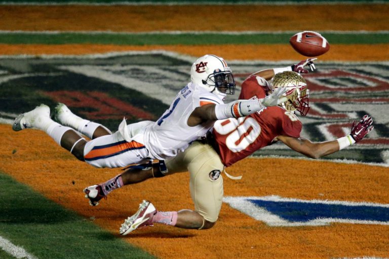 Auburn's Chris Davis and Florida State's Rashad Greene reach for the ball during the NCAA BCS National Championship college football game in January. (AP/Gregory Bull)