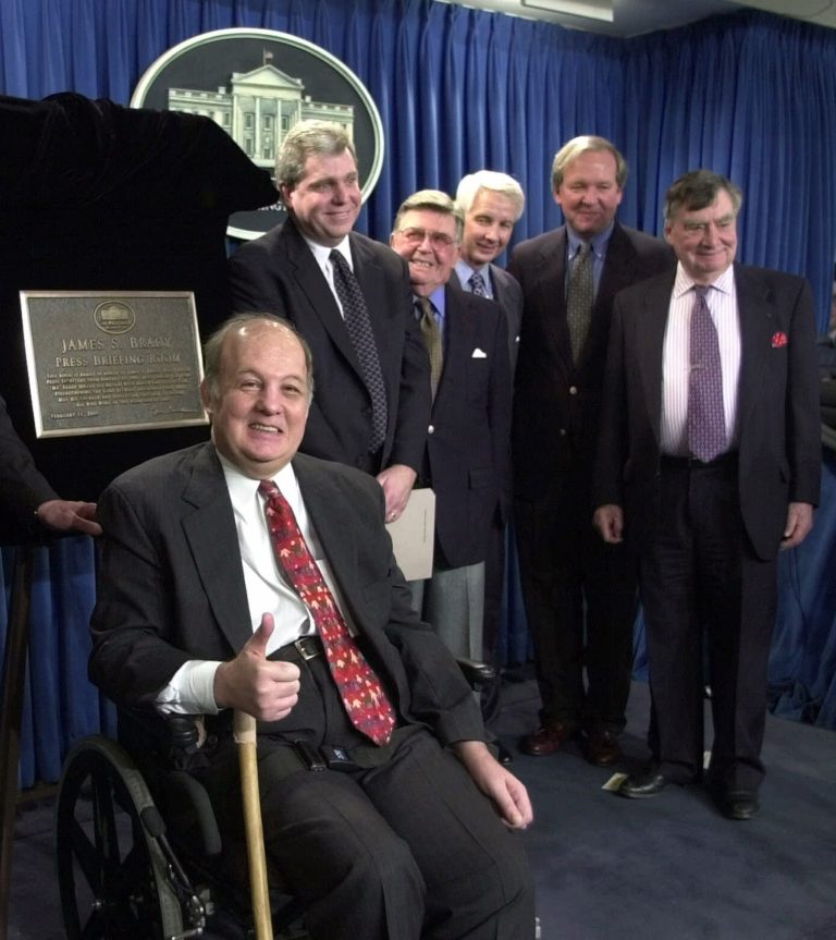 FILE - This Feb. 11, 2000 file photo shows former White House press secretary for President Reagan James Brady, left, in  a group photo following a dedication ceremony for the new James S. Brady Press Briefing Room at the White House in Washington. From left are, Brady, presidential press secretaries Joe Lockhart (Clinton), Jerald terHorst (Ford), Larry Speakes (Reagan), Mike McCurry (Clinton) and Pierre Salinger (Kennedy).  A Brady family spokeswoman says Brady has died at 73. (AP Photo/Susan Walsh/File)