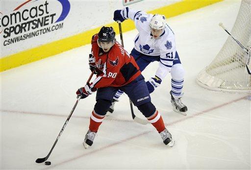 Washington Capitals center Marcus Johansson (90), of Sweden, skates with the puck against Toronto Maple Leafs defenseman Jake Gardiner (51) during the first period of an NHL hockey game, Friday, Dec. 9, 2011, in Washington.