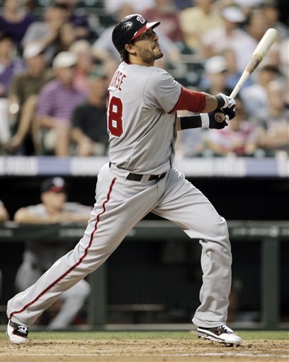 Washington Nationals' Ryan Zimmerman hits a double against the Colorado Rockies in the third inning of a baseball game in Denver, Tuesday, June 26, 2012. (AP Photo/Joe Mahoney)