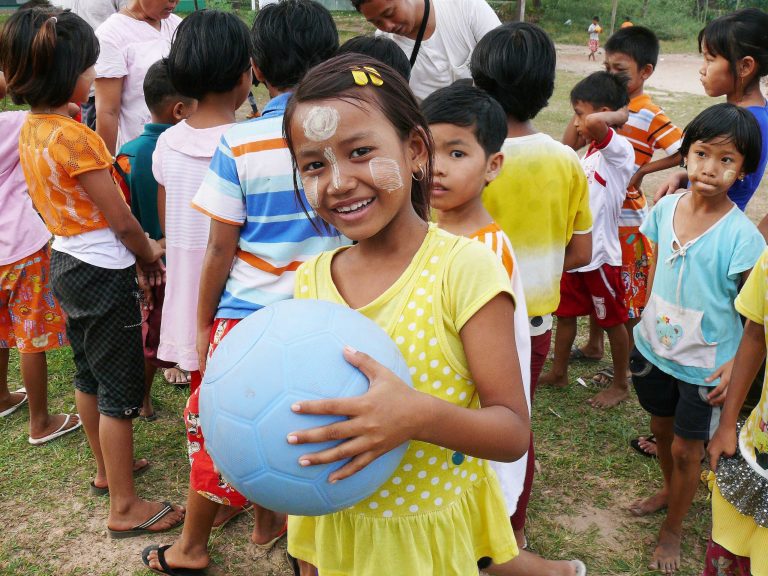 In this November 2013 photo provided by the One World Futbol Project, a school girl holds a blue One World Futbol at a school in Mawlamyine, Myanmar. The ball was part of a larger donation of 5,000 plus balls to the country. When Lisa Tarver and husband Tim Jahnigen set out four years ago to distribute their indestructible blue soccer balls to areas in need across the world, little did they know how far the project would evolve in just four years, in the span of a single World Cup cycle. Their One World Futbol project has shipped more than 850,000 soccer balls to organizations worldwide, touching the lives of some 30,000,000 children, many of whom would never have had access to such equipment or would have come up with their own version of a ball. (AP Photo/One World Futbol Project)