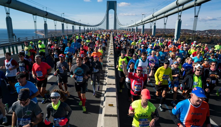 Runners cross the Verrazano-Narrows Bridge during the New York City Marathon last year. The organizers said this year's race will take place as scheduled for Sunday, but that media events on Wednesday have been postponed. (AP Photo/Craig Ruttle)