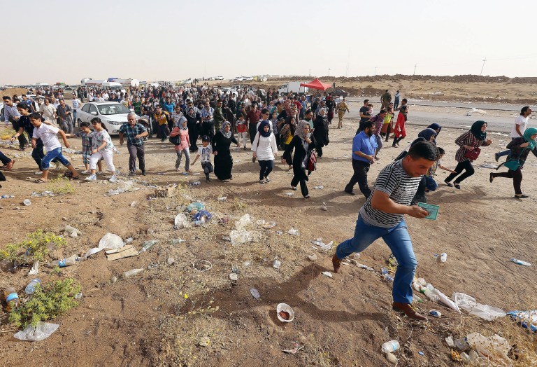 Refugees fleeing from Mosul head to the self-ruled northern Kurdish region in Irbil, Iraq, 350 kilometers (217 miles) north of Baghdad, Thursday, June 12, 2014. The Islamic State of Iraq and the Levant, the al-Qaida breakaway group, on Monday and Tuesday took over much of Mosul in Iraq and then swept into the city of Tikrit further south. An estimated half a million residents fled Mosul, the economically important city. (AP Photo)