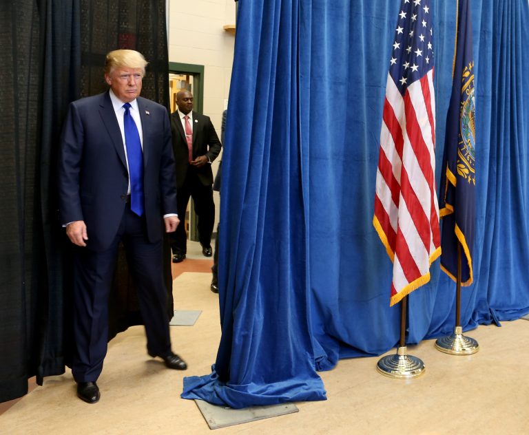 Republican presidential candidate businessman Donald Trump enters a media availability from behind a curtain, Wednesday, Aug. 19, 2015, at Pinkerton Academy in Derry, N.H. (AP Photo/Mary Schwalm)