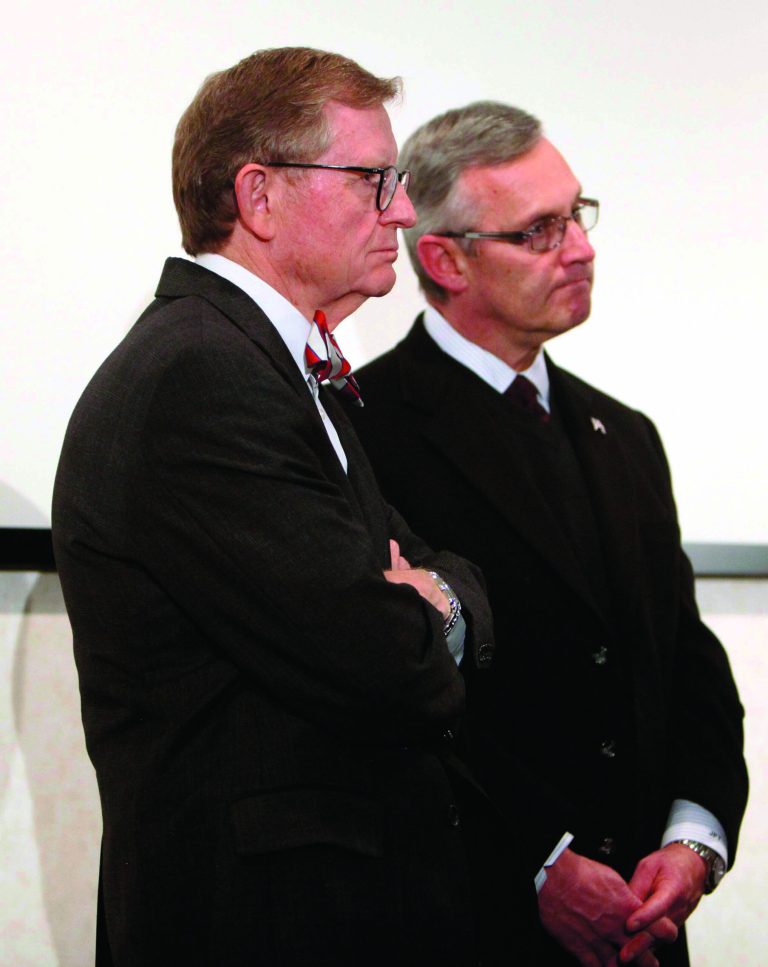 FILE - In this March 8, 2011 file photo, Ohio State football coach Jim Tressel, right, and university President E. Gordon Gee listen as athletic director Gene Smith speaks during a news conference in Columbus, Ohio. As the country absorbs the independent report released Thursday, July 12, 2012, on the Penn State sex abuse scandal, some see it as more than an indictment of one school. They see it as underscoring how major-college sports, football in particular, have run amok. When Gee heard Tressel concede he had reason to believe several star players were taking money and free tattoos from a suspected drug dealer and yet he had told no one, Gee was asked if he had considered firing Tressel. 