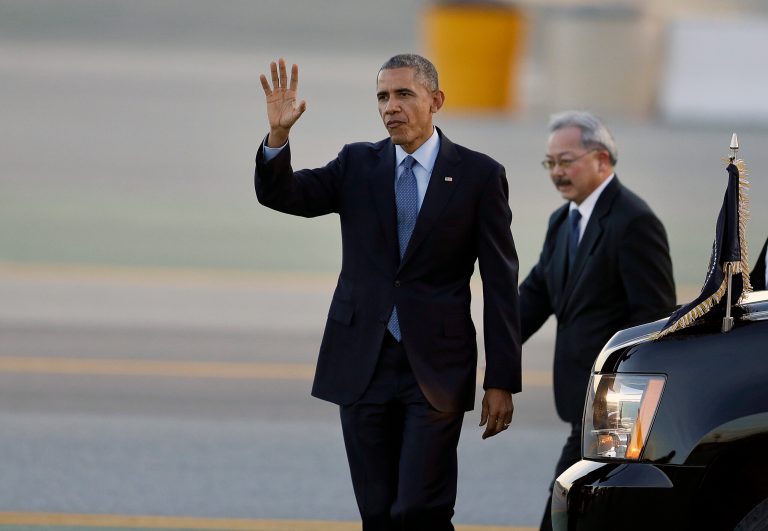 President Barack Obama, left, waves upon his arrival at San Francisco International Airport with San Francisco Mayor Ed Lee, right, Thursday, Feb. 12, 2015, in San Francisco. (AP Photo/Ben Margot)