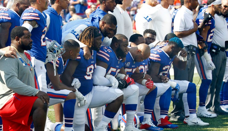 Buffalo Bills players take a knee during the playing of the national anthem prior to an NFL football game against the Denver Broncos, Sunday, Sept. 24, 2017, in Orchard Park, N.Y. (AP Photo/Jeffrey T. Barnes)