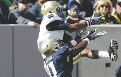 Rich Schultz/AP
Navy senior Kwesi Mitchell, bottom, was listed as a co-starter at three positions before cornerbacks David Wright and David Sperry emerged.