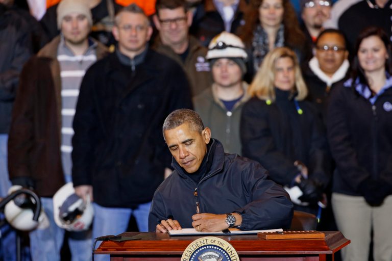 President Obama signs an executive order mandating that federal contractors be required to raise the minimum wage they pay their workers to $10.10, Wednesday, Jan. 29, 2014, at the end of an appearance at the US Steel's Mon Valley Works in West Mifflin, Pa. (AP Photo/Gene J. Puskar)