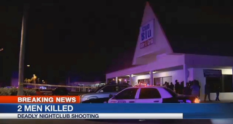 People gather near the scene of a fatal shooting at Club Blu nightclub in Fort Myers, Fla., Monday. (WBBH via AP)