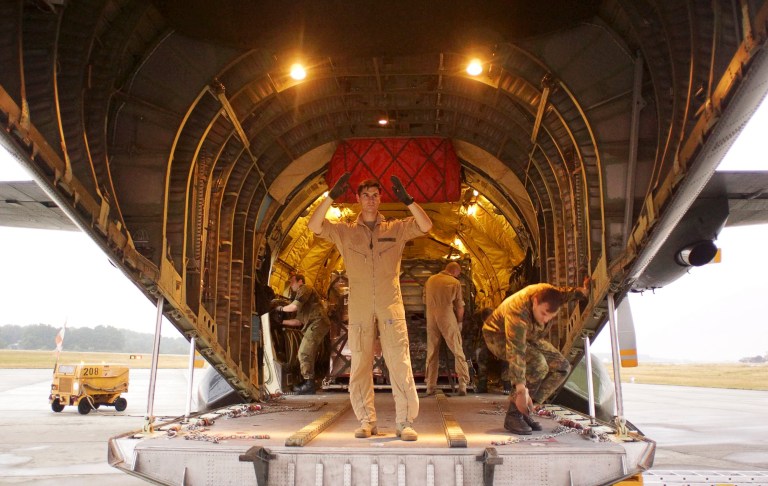 An airmen directs the loading of cargo into a Transall transport aircraft of German Bundeswehr at the airfield Hohn in Alt Duvenstedt, about 100km (60 miles) north of Hamburg, northern Germany, Friday, Aug. 15, 2014. Germany sends humanitarian aid as drinking water, blankets, medicine and food to Irbil, northern Iraq. (AP Photo/Martin Schlicht, pool)