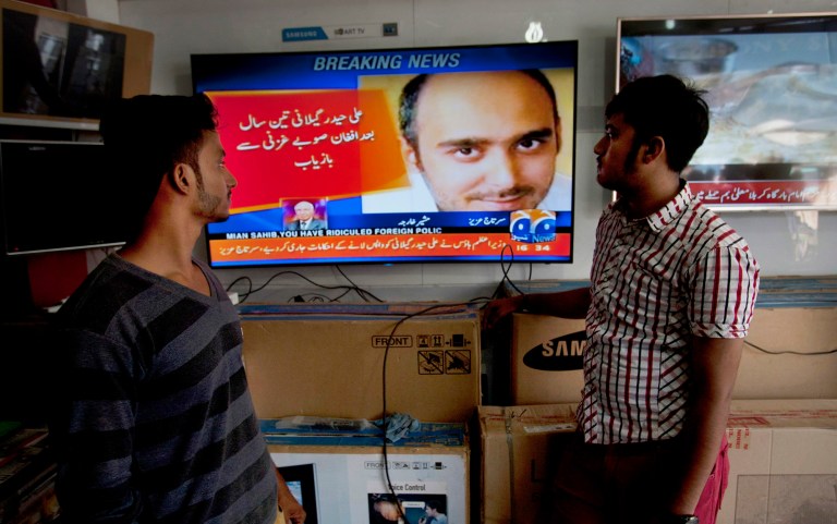 People watch news about the release of Ali Haider Gilani. A joint raid by U.S. and Afghan forces on Tuesday rescued the son of a former Pakistani prime minister from a three-year-long Taliban captivity in Afghanistan, officials said. (AP Photo/Shakil Adil)