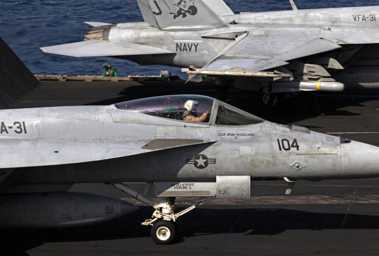 U.S. F/A-18 fighter jets prepare to take off for Iraq from the flight deck of the U.S. Navy aircraft carrier USS George H.W. Bush in the Persian Gulf, Monday, Aug. 11. (AP/Hasan Jamali)
