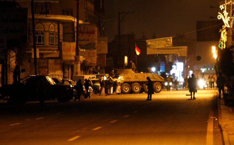 Yemeni soldiers secure a street leading to the central prison after an explosions in Sanaa, Yemen, Thursday, Feb. 13, 2014. Witnesses said explosions have rocked the Yemeni capital near the central prison followed by heavy gunfire and smoke billowing into the sky. (AP Photo/Hani Mohammed)