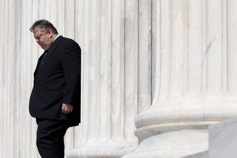 Greece's Deputy Prime Minister and Foreign minister Evangelos Venizelos stands at the entrance of Zappeion Hall before  an Informal meeting of Ministers for Foreign Affairs in Athens, on Friday, April 4, 2014. European Union foreign ministers meeting in Athens on Friday urged Russia to take concrete steps to pull troops back from its border with Ukraine but said they wanted to keep communication with Moscow open.(AP Photo/Petros Giannakouris)