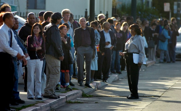   AC Transit supervisor Louise Batieste talks to commuters waiting for a bus to take them across the Bay Bridge after a fire in West Oakland shut down transbay service on Thursday, June 14, 2012. About 400,000 people take BART trains on a weekday, the transit agency said, but more commuters than usual were expected due to the opening round of the U.S. Open golf tournament and a San Francisco Giants afternoon baseball game. (AP Photo/Bay Area News Group, Kristopher Skinner)  
