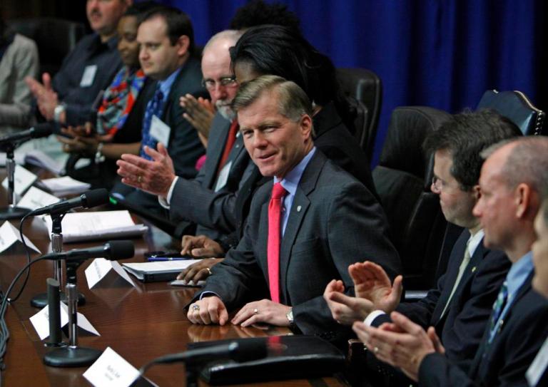 Virginia Gov. Bob McDonnell, center, reacts to applause on Thursday from state employees who attended a town hall meeting at the Patrick Henry Building in Richmond. 