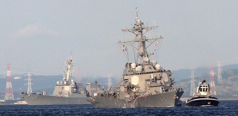 The Fitzgerald was towed back to base in Yokosuka, and Saturday evening a statement from the U.S. 7th Fleet said that the bodies of seven dead sailors were found in a berthing area of the vessel below the waterline. It wasn't immediately clear whether the sailors had drowned. (AP Photo/Eugene Hoshiko)