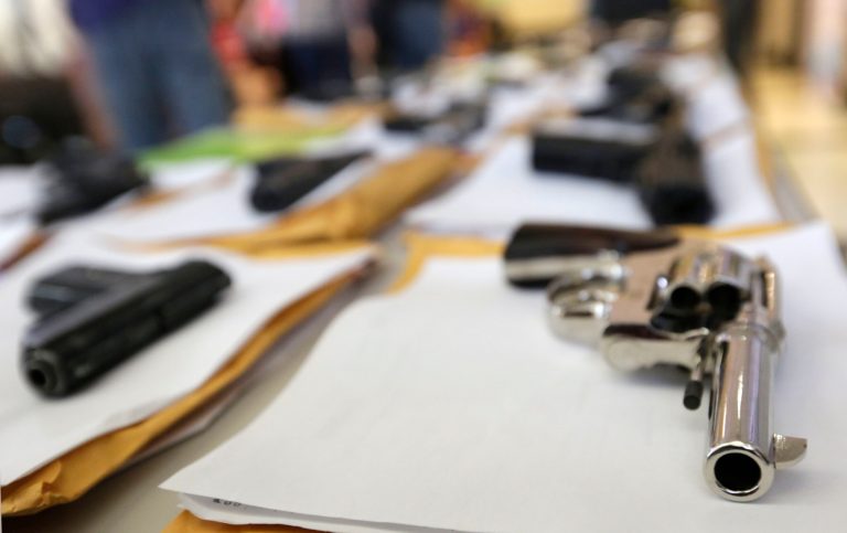 In this Monday, July 7, 2014, file photo, Chicago police display some of the thousands of illegal firearms they have confiscated so far this year in their battle against gun violence in Chicago. (AP Photo/M. Spencer Green)