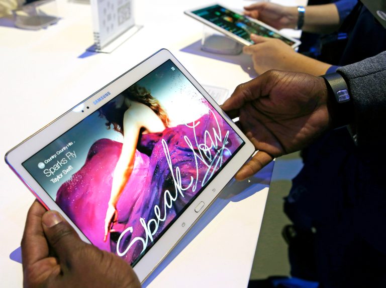 Members of the media try out samples of the Samsung Galaxy Tab S after the tablet was debuted at a press conference in New York, Thursday, June 12, 2014. The new Samsung tablets feature screens that are richer in color than standard LCDs.  The screens, known as AMOLED, for active-matrix organic light-emitting diodes, are already found in smartphones made by Samsung and a few other manufacturers. But until now, tablets haven't used them because larger AMOLED screens are more difficult to produce. (AP Photo/Kathy Willens)