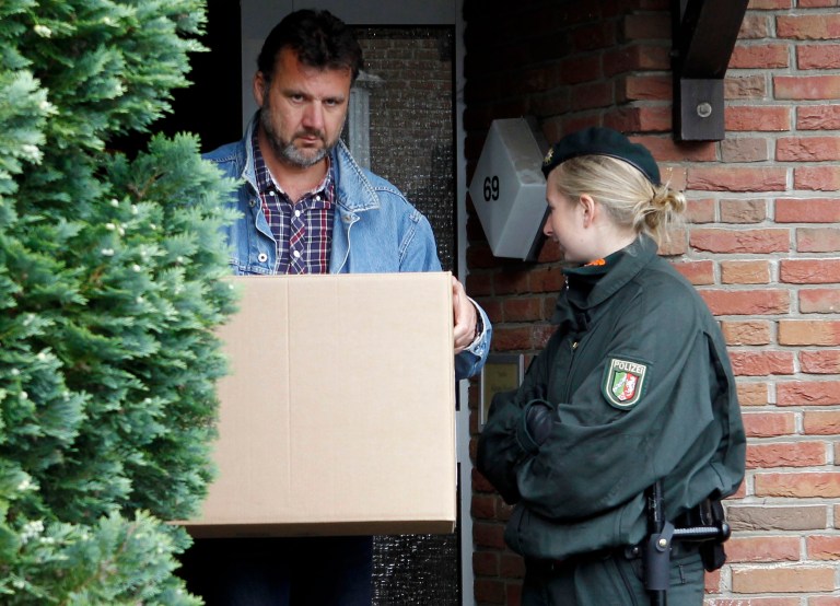   A police officer leaves a house where the head of an ultraconservative Islamic Salafist group lived after searching for evidence, in Cologne , western Germany, Thursday June 14, 2012. German authorities are conducting raids on properties linked to an ultraconservative Islamic organization after the interior minister banned the group. Interior Minister Hans-Peter Friedrich on Thursday banned the Salafist organization Millatu Ibrahim, saying it has been calling on Muslims to fight against Germany's 