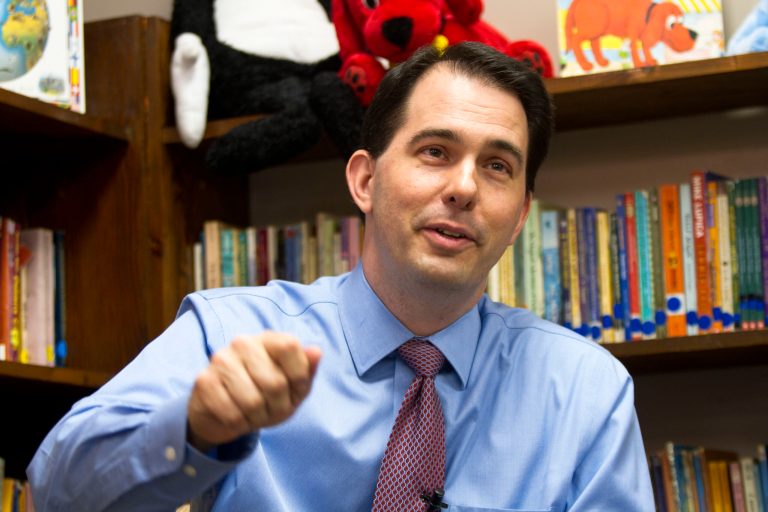 In this March 31, 2011 file photo, Scott Walker answers questions from the media after reading to Anna Greenman's third grade class at Hope Christian school Prima in Milwaukee, Thursday, March 31, 2011. (AP Photo/Darren Hauck)