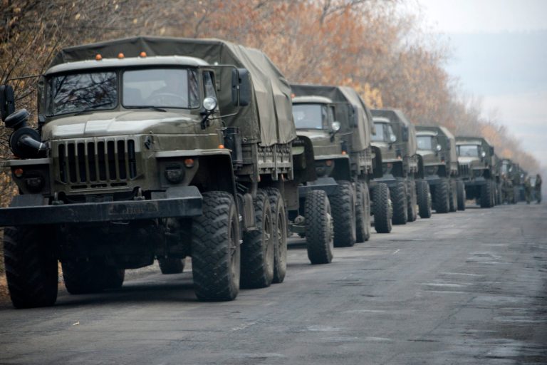 Unmarked military vehicles parked on a road outside the separatist rebel-held eastern Ukrainian town of Snizhne, 80 kilometers (50 miles) from Donetsk on Saturday Nov. 8, 2014. AP reporters saw more than 80 military vehicles on the move Saturday in separatist-controlled areas, indicating intensified hostilities may lie ahead. (AP Photo/Mstyslav Chernov)