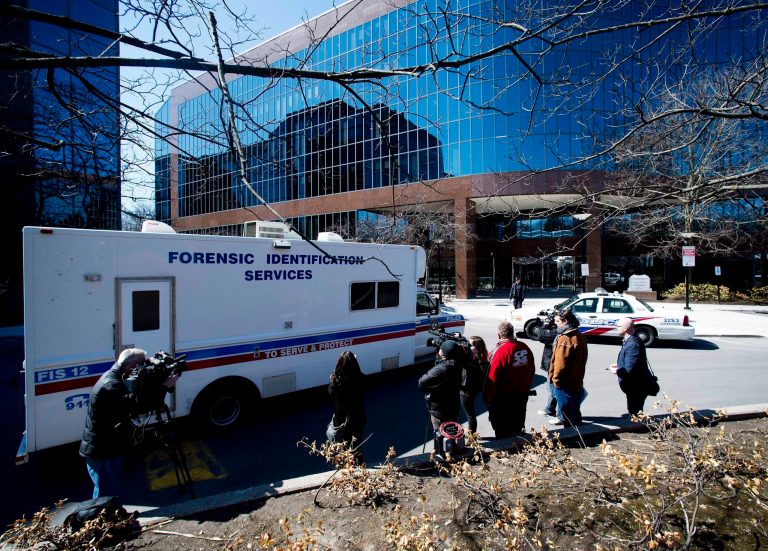 Toronto police's forensic unit arrives at an office building following a stabbing in Toronto, Wednesday, April 9, 2014. A man stabbed four of his colleagues at a Toronto office building before being subdued, police said Wednesday. (AP Photo/The Canadian Press, Nathan Denette)