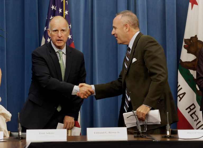 Gov. Jerry Brown, left, shakes hands with Senate President Pro Tem Darrell Steinberg, D-Sacramento, as they leave a meeting where a proposed water bond measure was discussed at the Capitol, Tuesday, Aug. 12, 2014, in Sacramento, Calif.  Brown, Steinberg and Assembly Speaker Toni Atkins, D-San Diego,  and other lawmakers met with representatives of more than twenty business, agricultural and environmental groups to get their support for a $7 billion bond proposal to replace the $11.1 billon bond measure that is currently on the November ballot.(AP Photo/Rich Pedroncelli)
