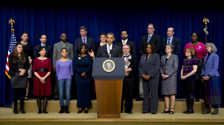 President Obama speaks about the Affordable Care Act on Tuesday in the Eisenhower Executive Office Building in Washington in front of 18 people who the White House has not named. (AP Photo/Carolyn Kaster)