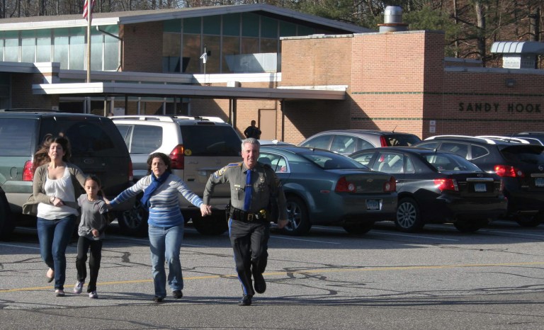 Newtown's first selectwoman says the next few weeks will be difficult and she is asking residents to quietly mark the anniversary of the Dec. 14 shooting at Sandy Hook Elementary School by coming together and supporting local businesses. (AP Photo)
