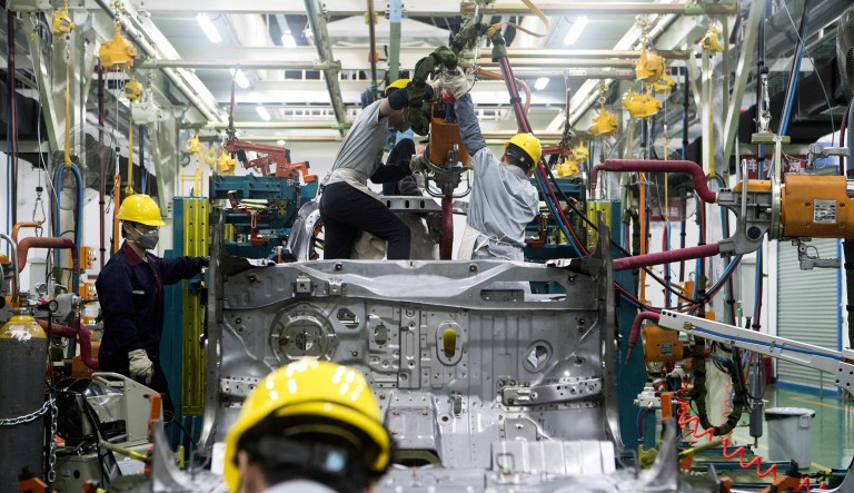 Workers assemble a vehicle at the XpengÂ Motors Technology Ltd. prototype center in Guangzhou, China, on Wednesday.