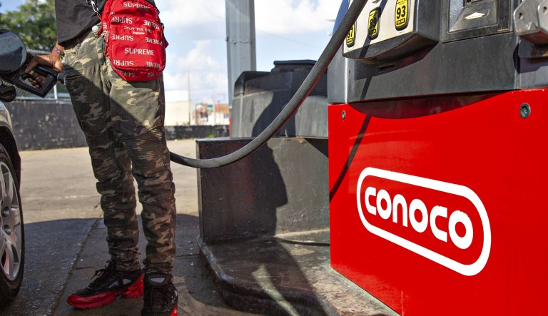 A customer fuels a vehicle at a ConocoPhillips gas station in Peoria, Illinois, U.S., on Tuesday, July 24, 2018. ConocoPhillips is scheduled to release earnings figures on July 26.