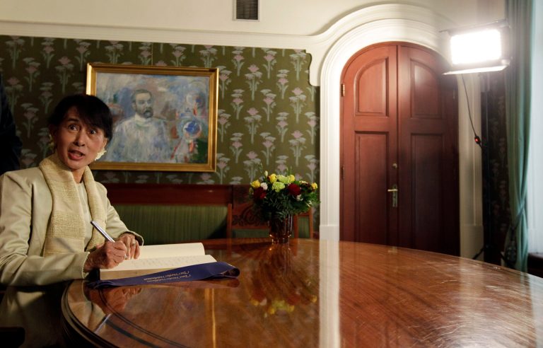   Myanmar opposition leader Aung San Suu Kyi signs a book at the Nobel Institute after a meeting with the Norwegian Nobel Committee members in Oslo, Norway, Saturday, June 16, 2012. It's been 21 years, and Burmese opposition leader Aung San Suu Kyi is about to give her Nobel Peace Prize acceptance speech. (AP Photo/Cathal McNaughton, Pool)  