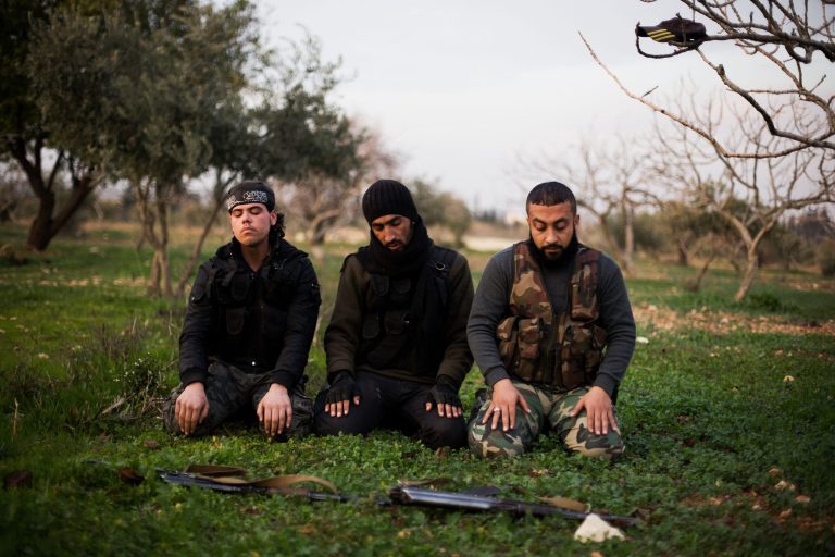   FSA fighters pray after an attack on a Military Academy in Tal Sheer village, north of Aleppo province, Syria, Thursday, Dec 13, 2012. (AP Photo / Manu Brabo)  
